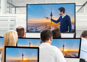 Broadcast training session with an instructor explaining technical setups on a large screen.